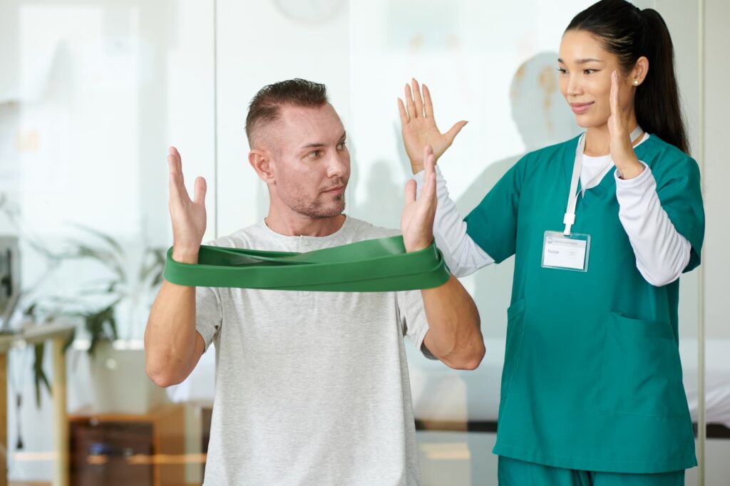 Patient using resistance bands during physical medicine therapy in Tucson